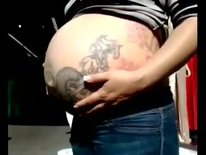 Tattoos all over her pregnant belly