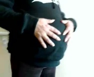 Pregnant woman in hooded sweatshirt