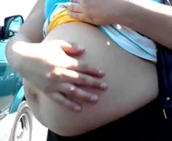 Pregnant woman after putting groceries into her car
