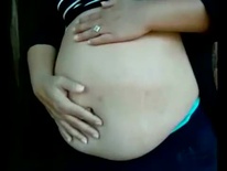 With her pregnant belly out