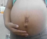 Pregnant belly with a belly ring scar