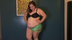 Belly dancer shows the effects of fast food on her body.