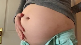 Growing belly playing in tight clothes